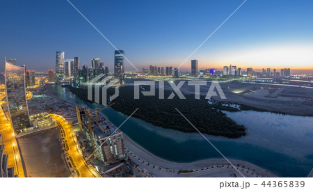 Buildings on Al Reem island in Abu Dhabi day to night timelapse from above. Buildings on Al Reem island in Abu Dhabi day to night timelapse from above. 44365839