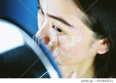 Asian woman applying cosmetics makeup. Asian woman applying cosmetics makeup. 44366931