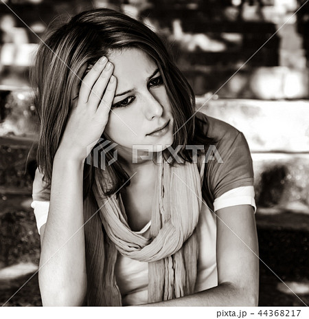 Sad girl at garden. Sad girl at garden. 44368217
