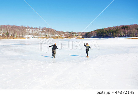 Couple skating on the frozen lake Couple skating on the frozen lake 44372148
