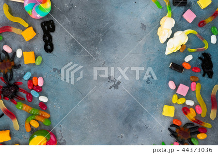 Colorful halloween candies on stone 44373036