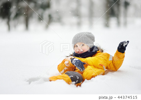 Little boy having fun in the snow Little boy having fun in the snow 44374515