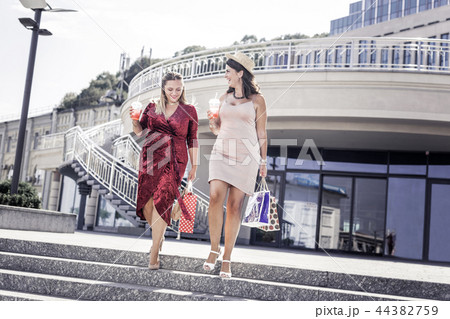 Joyful nice female friends going shopping together 44382759