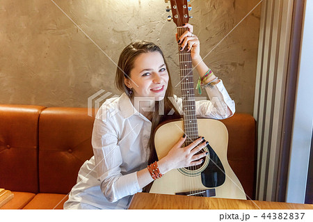 girl playing guitar at Cafe girl playing guitar at Cafe 44382837