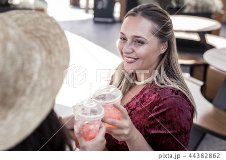 Delighted happy nice women drinking lemonade together Delighted happy nice women drinking lemonade together 44382862