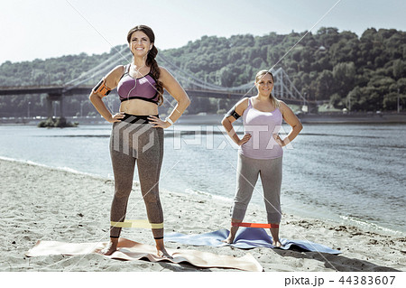 Joyful cheerful curvy women smiling to you 44383607