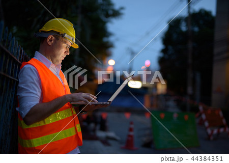 Mature man construction worker at the construction site in the c Mature man construction worker at the construction site in the c 44384351