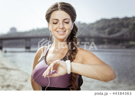 Delighted positive nice woman checking the time 44384363