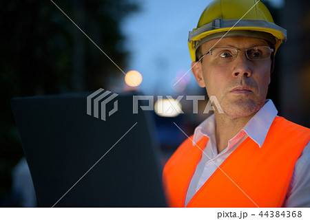 Mature man construction worker at the construction site in the c Mature man construction worker at the construction site in the c 44384368