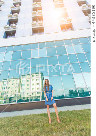 Fashion urban portrait of beautiful model on the street. Young slim woman wearing blue dress in the 44385190