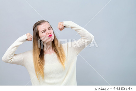 Powerful young woman in success pose 44385247