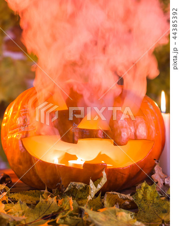 Jack-o-Lantern halloween pumpkin with mist pouring from its mouth 44385392