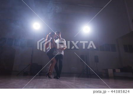 Young couple dancing latin dance Bachata, merengue, salsa. Two elegance pose in dance class Young couple dancing latin dance Bachata, merengue, salsa. Two elegance pose in dance class 44385824