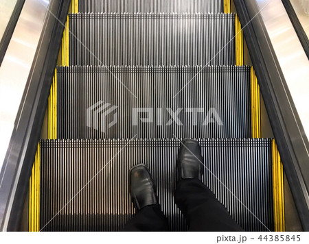 Businessman wore standing on the escalator. 44385845