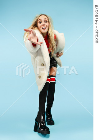 Full-length portrait young elegant woman at studio. Female fashion and shopping concept 44386179