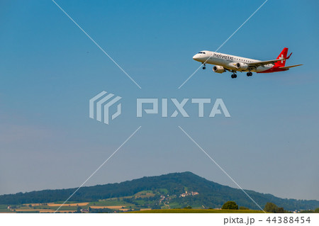 Helvetic Swiss airlines airplane preparing for landing at day time in international airport 44388454