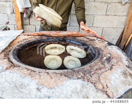 Traditional Uzbek flatbread baking in the tandyr Traditional Uzbek flatbread baking in the tandyr 44388605