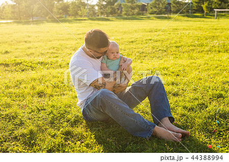 Happy father holding baby son on nature. Concept of happy family, father's day and child. 44388994