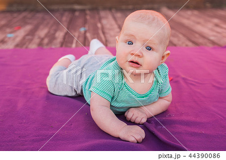 Cute child baby boy lying on blanket in summer day on nature. Family picnic in a park. Cute child baby boy lying on blanket in summer day on nature. Family picnic in a park. 44390086