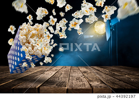 Popcorn explosion on old wooden table. Popcorn explosion on old wooden table. 44392197