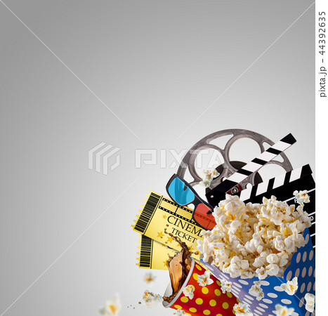 Pop-corn, movie tickets, clapperboard and other things in motion. Pop-corn, movie tickets, clapperboard and other things in motion. 44392635