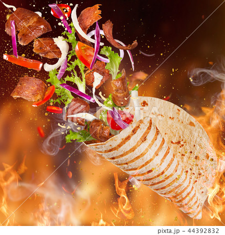 Kebab sandwich with flying ingredients. Kebab sandwich with flying ingredients. 44392832