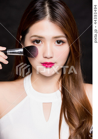 woman take makeup brush woman take makeup brush 44393494