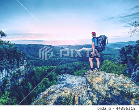 Professional photographer with tripod on cliff. Professional photographer with tripod on cliff. 44396318