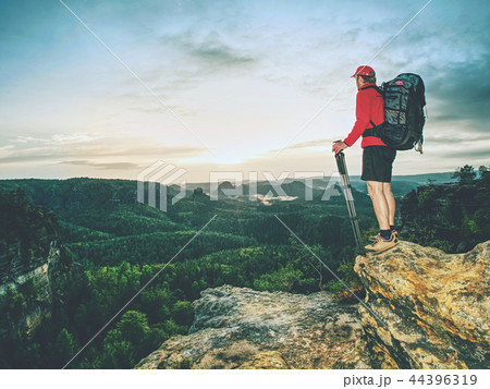 Photographer with backpack and tripod in hands Photographer with backpack and tripod in hands 44396319