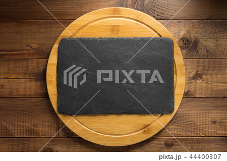 slate stone at wooden cutting board slate stone at wooden cutting board 44400307