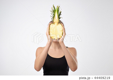 Young caucasian girl holding Pineapple. Young caucasian girl holding Pineapple. 44409219