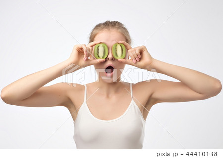 Kiwi. Healthy fruit funny woman holding kiwi fruit for her eyes. 44410138