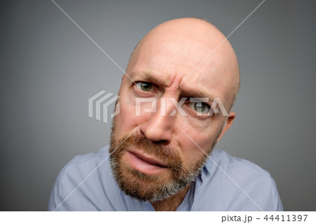 Bald mature guy in gray casual shirt discovering hidden camera. 44411397