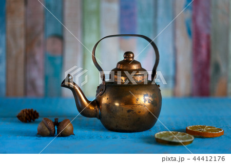 Copper kettle on wooden background 44412176