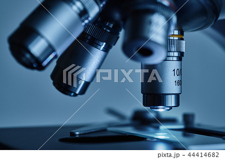 Modern microscope with metal lens at laboratory. 44414682