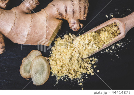 dry spices ginger in a wooden scoop dry spices ginger in a wooden scoop 44414875