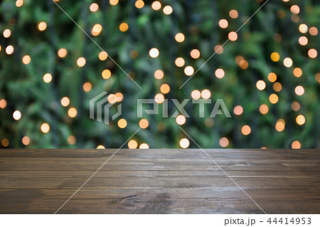 Blurred gold garland and wooden tabletop. Blurred gold garland and wooden tabletop. 44414953