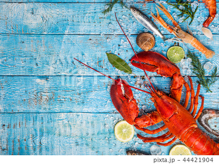 Fresh tasty seafood served on old wooden table. Fresh tasty seafood served on old wooden table. 44421904