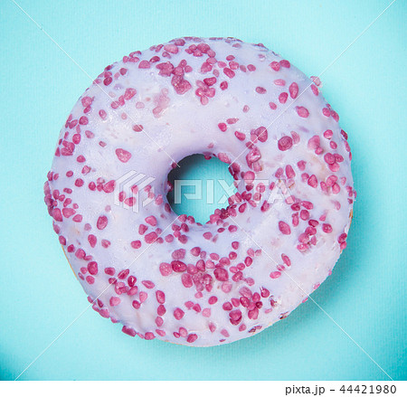 Glazed donut with colorful sprinkles on blue pastel background. Glazed donut with colorful sprinkles on blue pastel background. 44421980