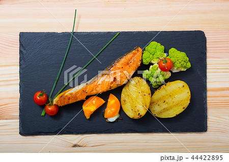 Grilled salmon with egg yolk and vegetables Grilled salmon with egg yolk and vegetables 44422895