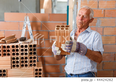 Man working with red brick Man working with red brick 44424262