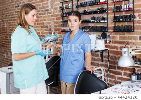 women nail masters standing at workplace women nail masters standing at workplace 44424320