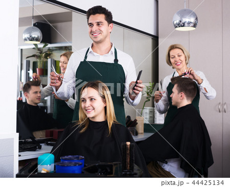 Hairdresser cuts hair at salon Hairdresser cuts hair at salon 44425134