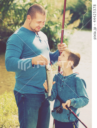 Man and little boy fishing Man and little boy fishing 44425378