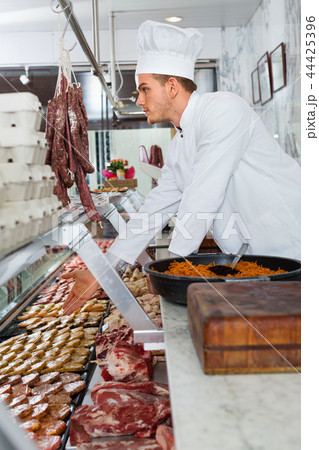 Professional cook sniffing freshly cooked dish Professional cook sniffing freshly cooked dish 44425396