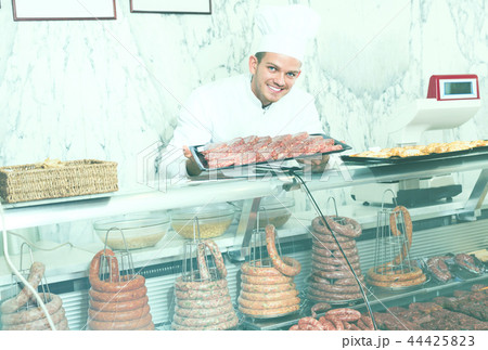 Laughing professional cook laying out food 44425823