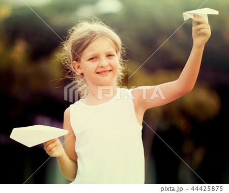 girl playing paper airplanes 44425875