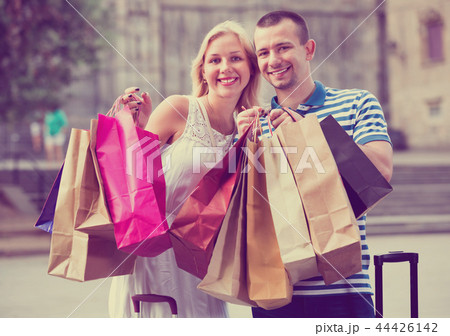 Young man and woman holding shopping paper bags Young man and woman holding shopping paper bags 44426142