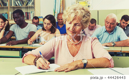 Mature woman take a written exam 44426443