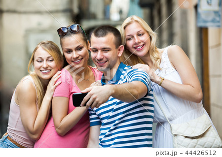 Four young cheerful persons taking self picture 44426512